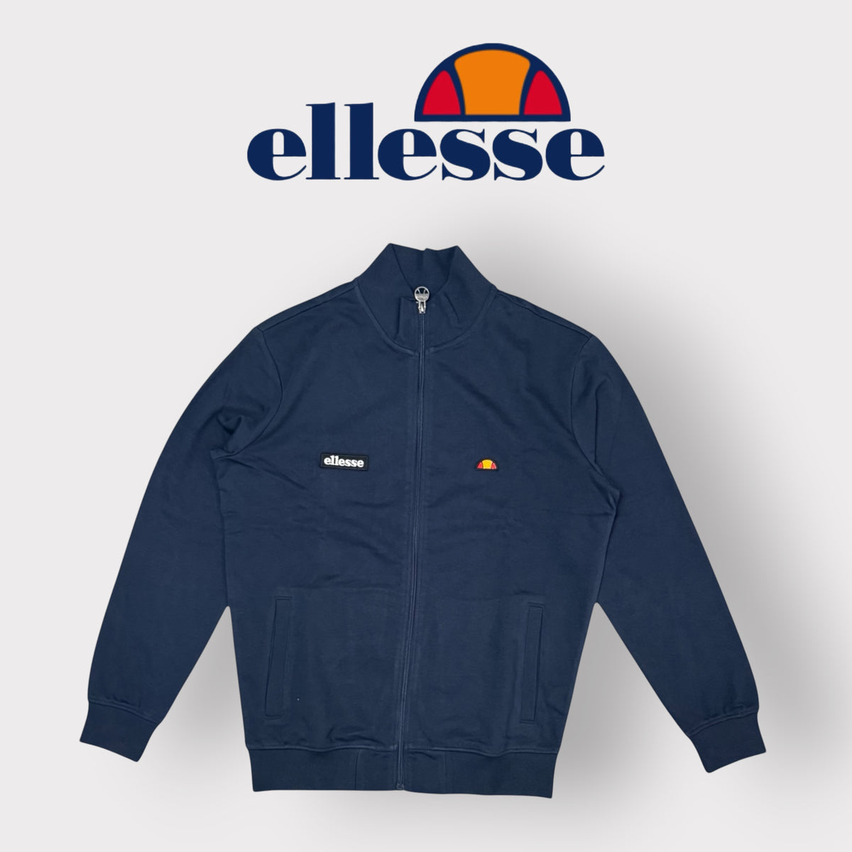 ELLESSE - Felpa Uomo con logo ricamato lato cuore, con colletto e zip, Col.Blu